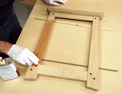 Applying oil stain to calendar frame