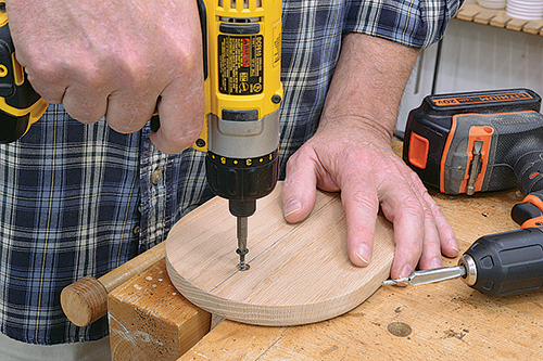 Screwing arm anchor in place in banana hanger base