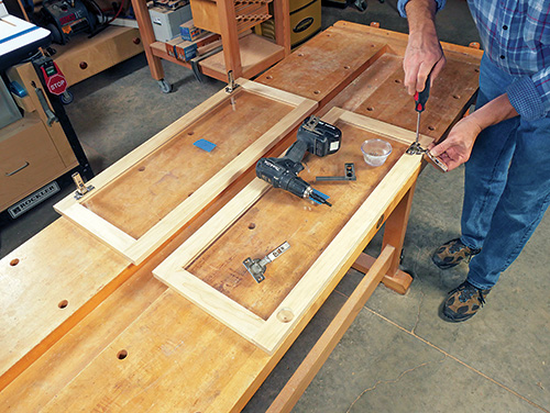 Installing cup hinge in battery cabinet door