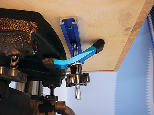 Clamp mounted underneath drill press table