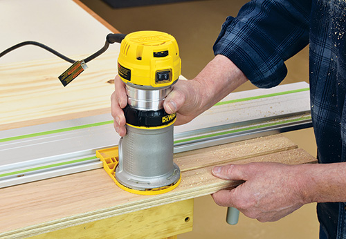 Hand router attached to track saw rail