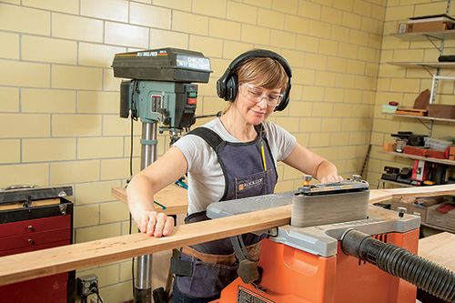 Sanding cedar potting bench top slats