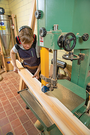 Using band saw to cut wave shaped pattern in cedar slats