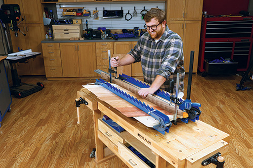 Applying central clamp to laminate glue-up