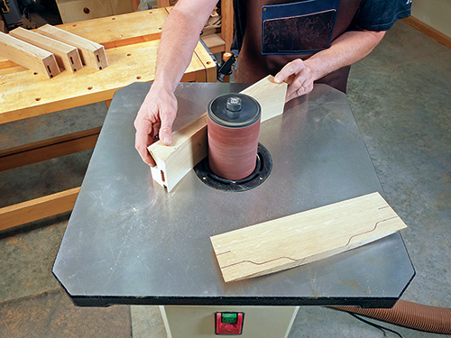 Smoothing cloud lift dining chair back rails with spindle sander