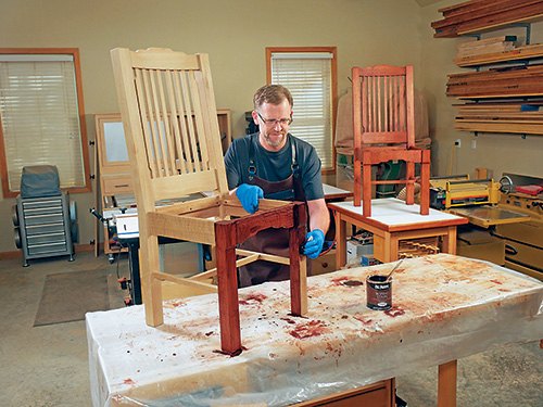 Wiping mahogany stain onto cloud lift dining chairs