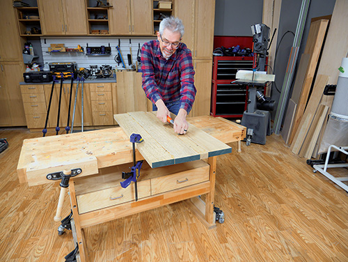 Scraping surface of tabletop wood planks