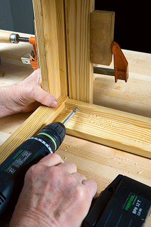 Screwing bench slats into place on compact bench