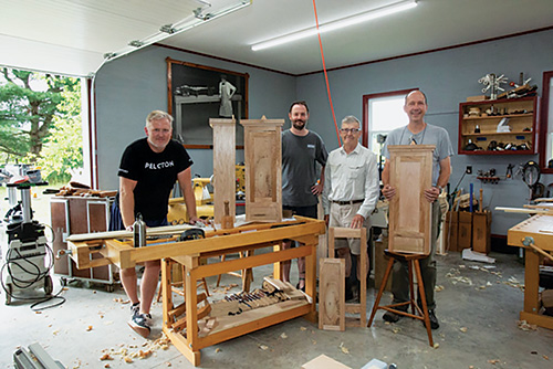 Ernie Conover teaching hand tool techniques to three students