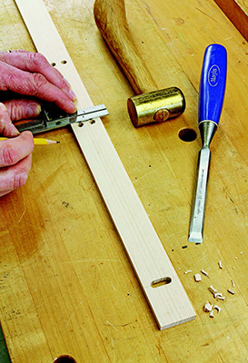 Slotted holes in the front positioning fence enable you to move it forward or backward as needed. To make these slots, drill two end holes each and chisel away the waste in between them.