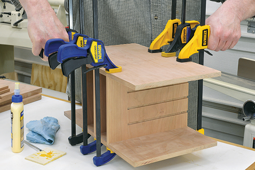 Begin the assembly with the center module, being sure to orient the top drawer shelf with the dadoes facing upward.