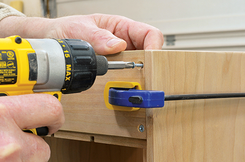 Glue and screw the back of the upper storage compartment into place. This creates a rabbet underneath that will later accept the desk back.