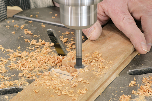 Use a small Forstner bit to clear out most of the waste from the inside of the secondary mortise. Be sure to set the drill press depth stop.