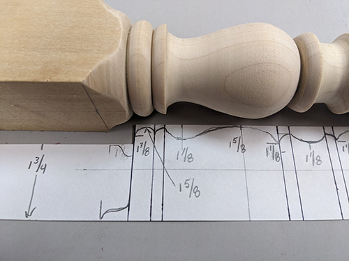 Story stick with lines and measurements marked on it