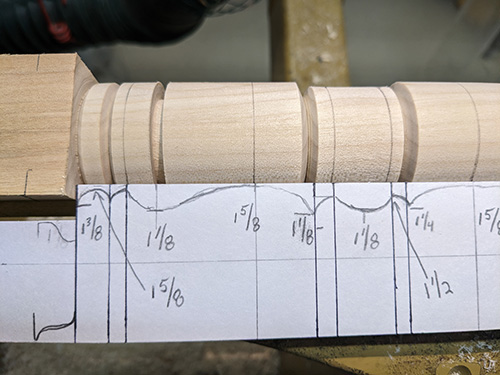 Using story stick to lay out grooves on stool leg turning