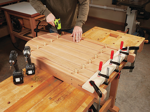 Assembling adirondack chair back and screwing together