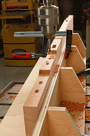 The author settled on a drill press and Forstner bits to cut the bed's many mortises. Given their various stepped elevations, set and check your drilling depth carefully as you proceed.