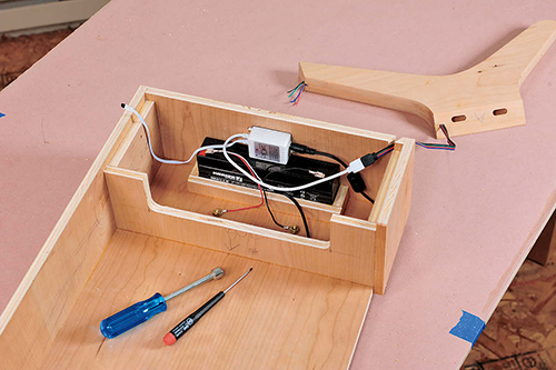 The sealed lead-acid battery, control box and wiring for the table's LED lighting are neatly mounted inside the drawer box.