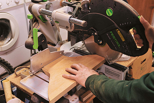 With the beveled side against the miter saw fence, the top of the leg blank (where it joins the frame) is cut square.