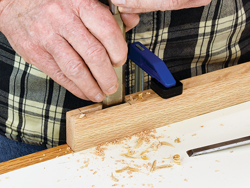 Cleaning mortise hole with a chisel