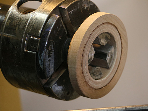 Tenon ring mounted on lathe for sanding