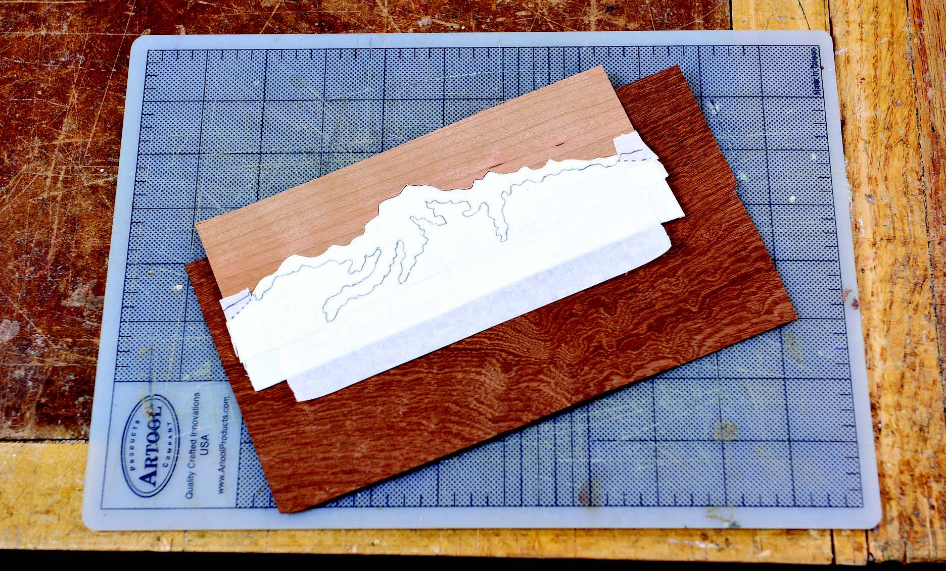 There can be more than one piece of veneer assembled for a cut. Here, the Snow-2 veneer is attached to Sky-1, which was cut out previously. Sky-1 and Snow-2 are now the background, while Mountain-3 is behind them all.