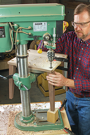 Add a scrap block under the leg to brace it when drilling.