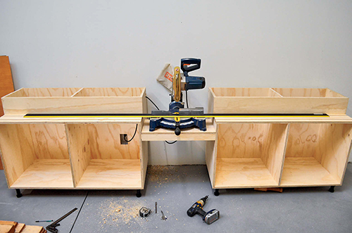 Use a straightedge to adjust the shelf until the bed of the miter saw is exactly in line with the cut shelves,