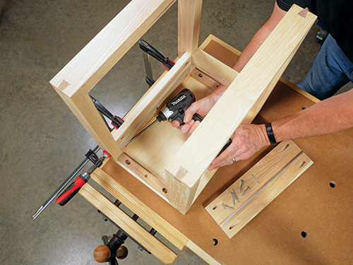 Screwing pocket hole screws into nesting table apron