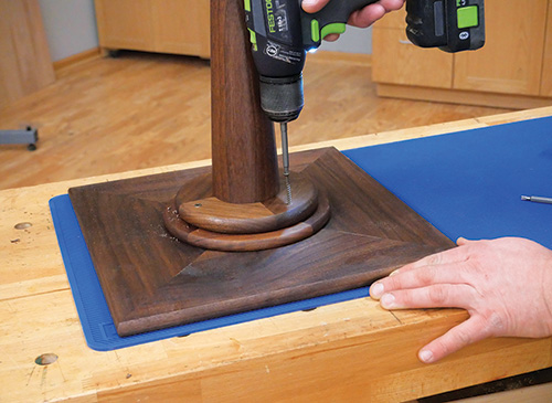 Adding coverable screw holes to the base of pedestal stand