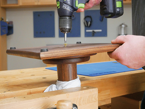 Attaching non-slip feet to the base of pedestal stand