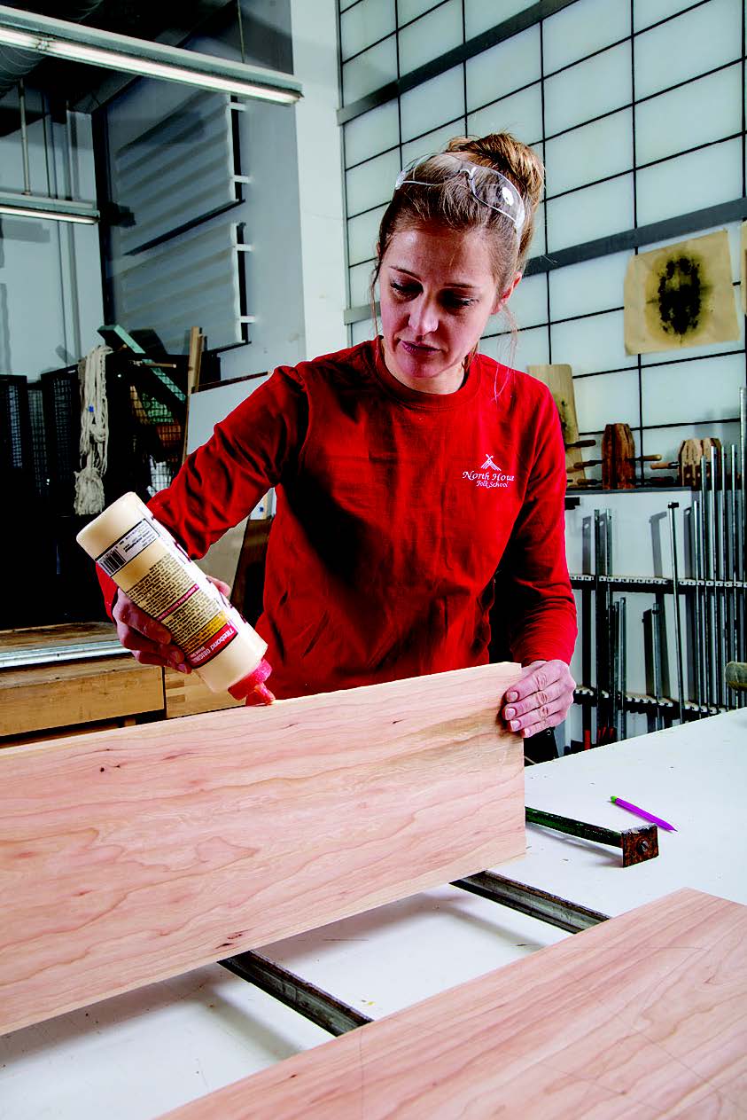 The author glues and clamps pieces for the tabletop together.