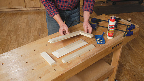 Parts for a raised panel drawer face laid out and ready for assembly