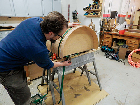 Use ratcheting tie-down straps to clamp the laminations around the form. The more clamps, the better. Let the arc cure overnight before removing the clamps.