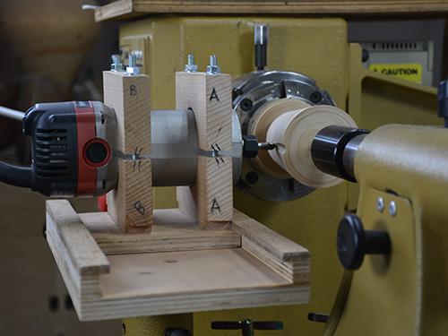 Router jig used to cut rounded grooves in turned piece