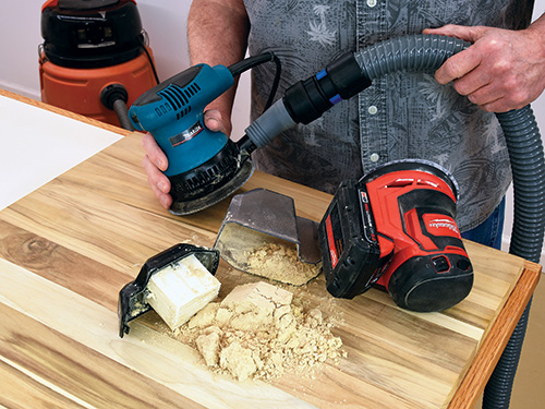 Emptying dust tray from hand sander