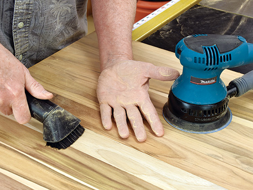 Vacuuming wood between sanding passes