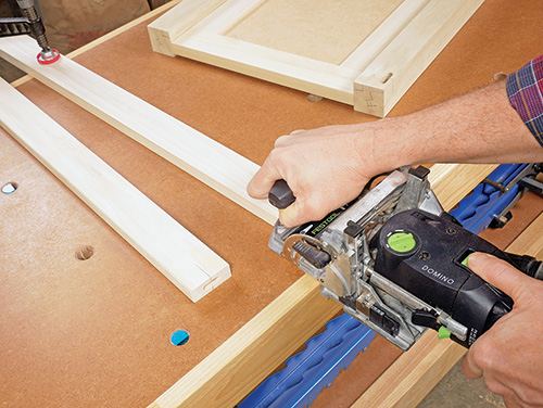 Cutting domino slots in cabinet legs