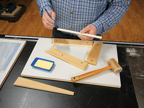 Gluing up ends of lamp shade parts in jig