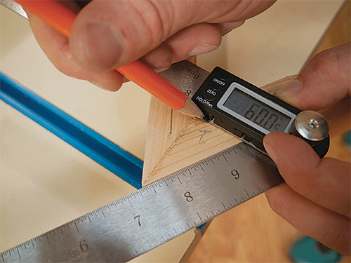 Marking out positioning of dowel joint with digital angle gauge