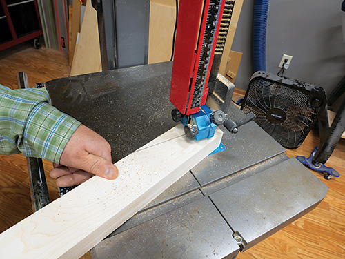 Using band saw to cut top portion of standing desk supports