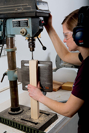 A drill press with table set vertically and your wood clamped...