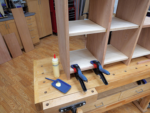 Using bandy clamps to hold eding on tansu panels during glue-up