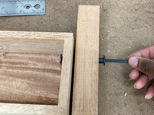 Tightening bolt that connects planter box to tiered frame
