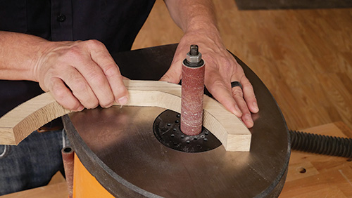 Shaping center support pieces for plant stand on spindle sander