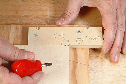 Marking pivot point on scrap wood before cutting tilting mechanism