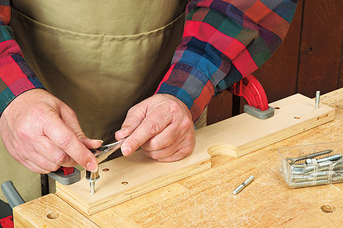 Screwing hanger bolts into tilt top router table router plate