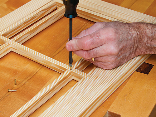 Adding decorative brass screws to window lattice