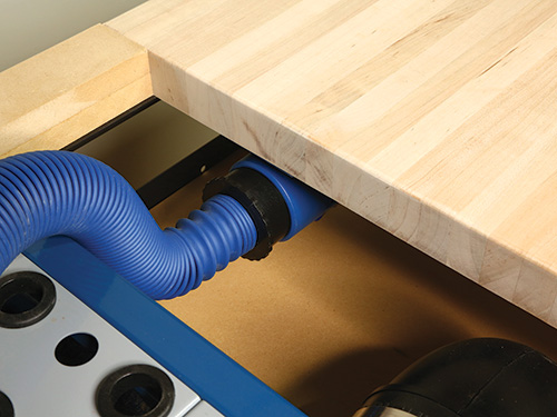 Close-up of dust hose connection under sanding cart tabletop