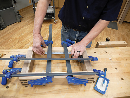 Clamping sides of box joint for tray